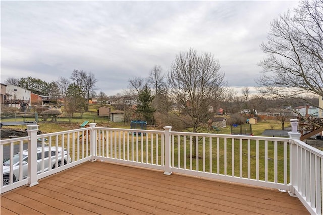 wooden terrace with a residential view, a playground, and a lawn