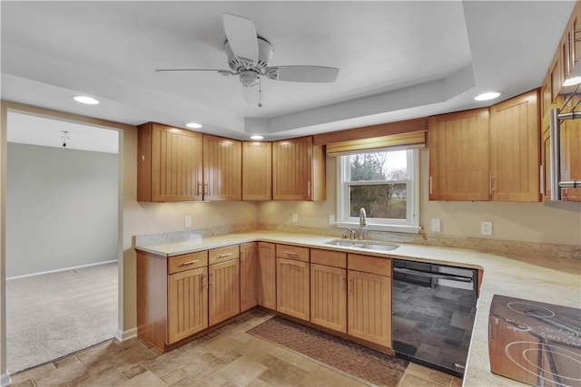 kitchen with black appliances, light countertops, a sink, and recessed lighting