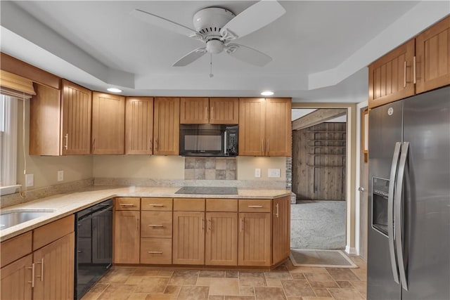 kitchen featuring black appliances, ceiling fan, stone finish floor, and recessed lighting