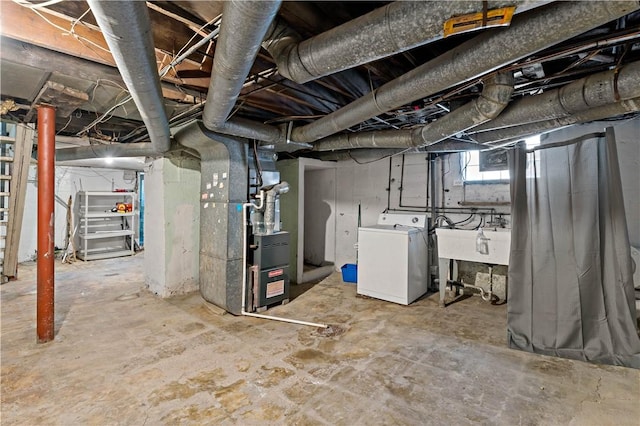 below grade area featuring washer / dryer and heating unit