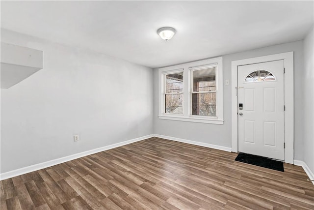 foyer entrance featuring baseboards and wood finished floors