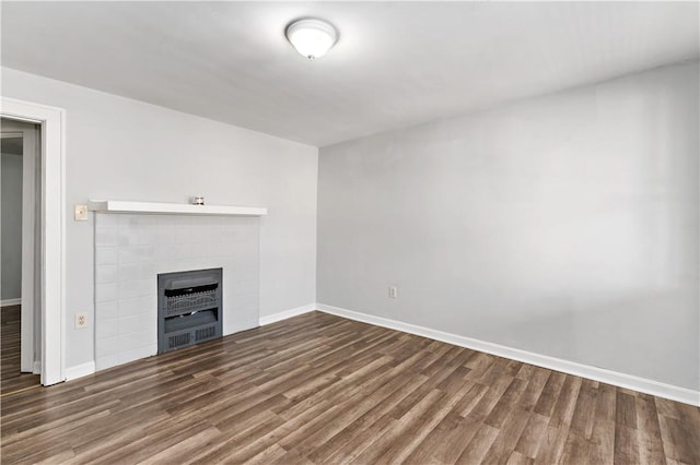 unfurnished living room featuring baseboards and wood finished floors