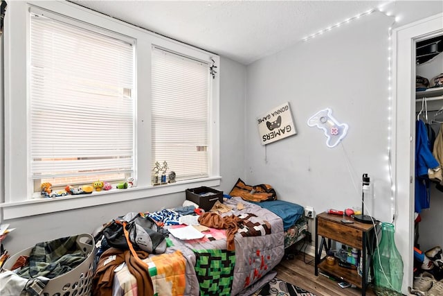 bedroom with a closet and wood finished floors