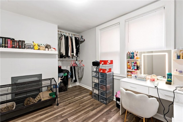 interior space featuring a fireplace, baseboards, and dark wood-type flooring