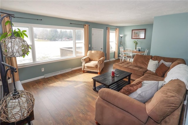 living area with visible vents, baseboards, and wood finished floors