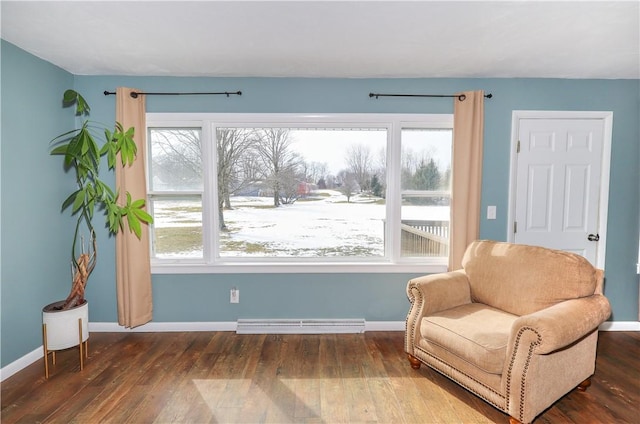 living area featuring baseboards, visible vents, and wood finished floors