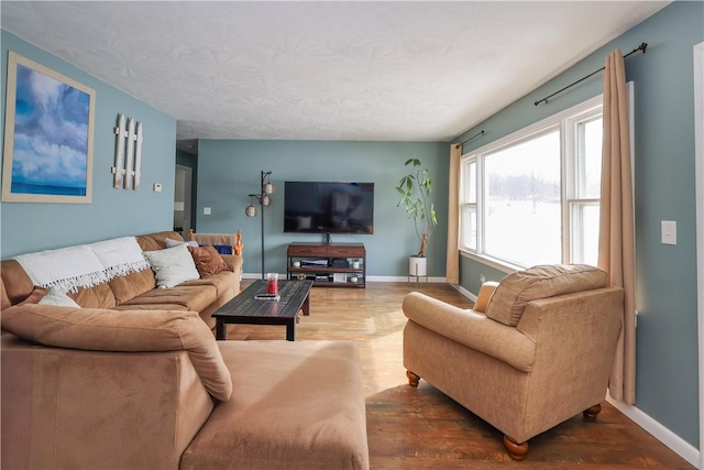 living area featuring dark wood-style flooring and baseboards