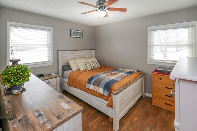 bedroom with dark wood-style floors and multiple windows