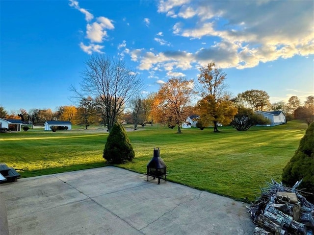 view of home's community featuring a patio area and a lawn