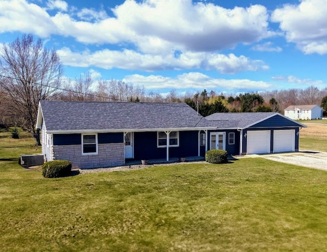 ranch-style home featuring driveway, a front yard, an attached garage, and stone siding