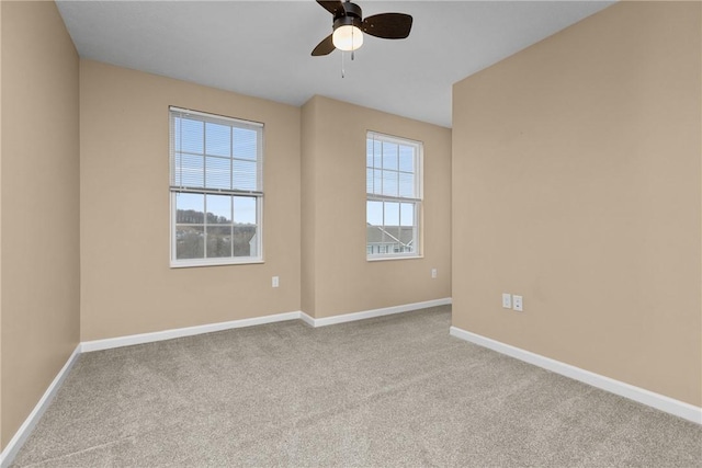 unfurnished room featuring carpet, plenty of natural light, and baseboards