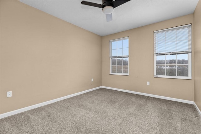 unfurnished room with ceiling fan, carpet flooring, and baseboards