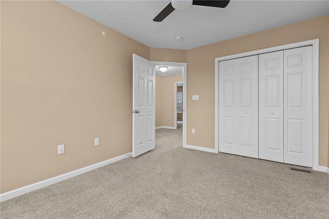 unfurnished bedroom with visible vents, a closet, baseboards, and carpet flooring