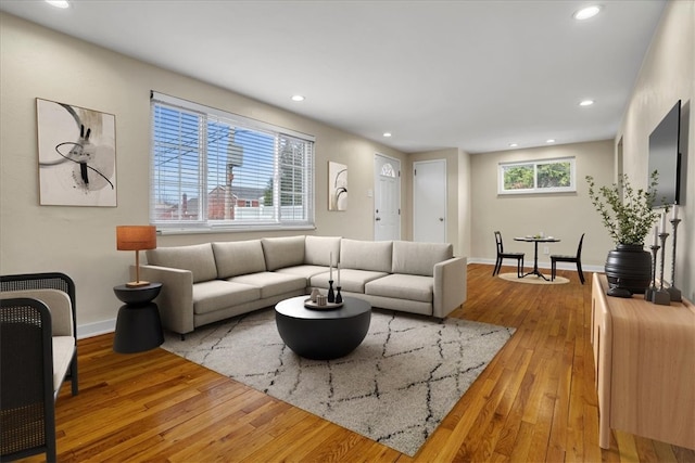 living room with recessed lighting, baseboards, and hardwood / wood-style floors