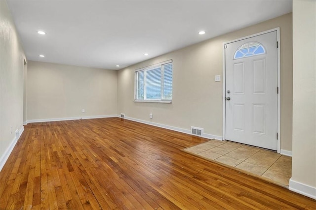 entrance foyer with baseboards, visible vents, hardwood / wood-style floors, and recessed lighting