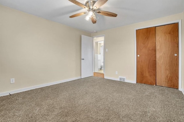 unfurnished bedroom with a closet, visible vents, a ceiling fan, carpet flooring, and baseboards