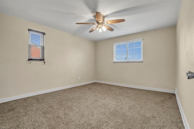 unfurnished room with a ceiling fan, baseboards, and carpet flooring