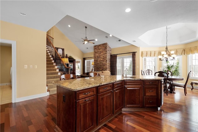 kitchen featuring dark wood-style floors, hanging light fixtures, and plenty of natural light