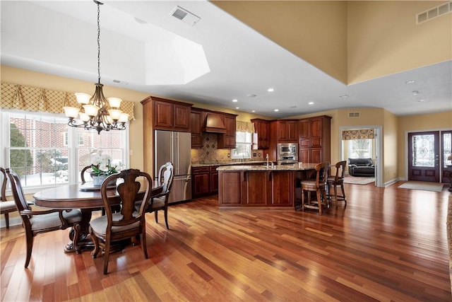 dining room featuring hardwood / wood-style flooring, a chandelier, and recessed lighting