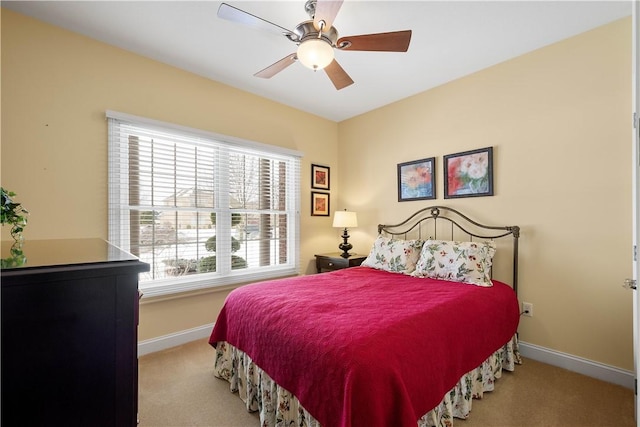 bedroom with carpet floors, ceiling fan, and baseboards