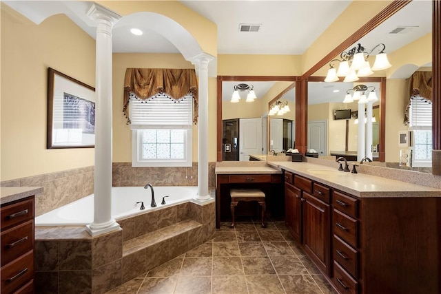 full bathroom featuring vanity, a garden tub, visible vents, and ornate columns