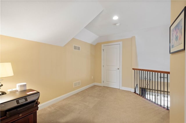 bonus room with visible vents, vaulted ceiling, light carpet, and baseboards