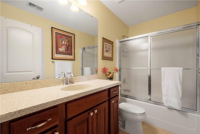 full bathroom with visible vents, bath / shower combo with glass door, toilet, tile patterned floors, and vanity