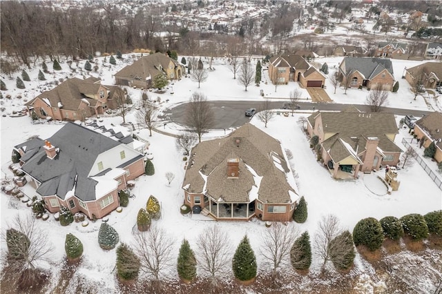 snowy aerial view with a residential view