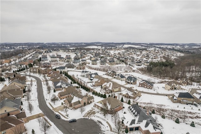 snowy aerial view featuring a residential view