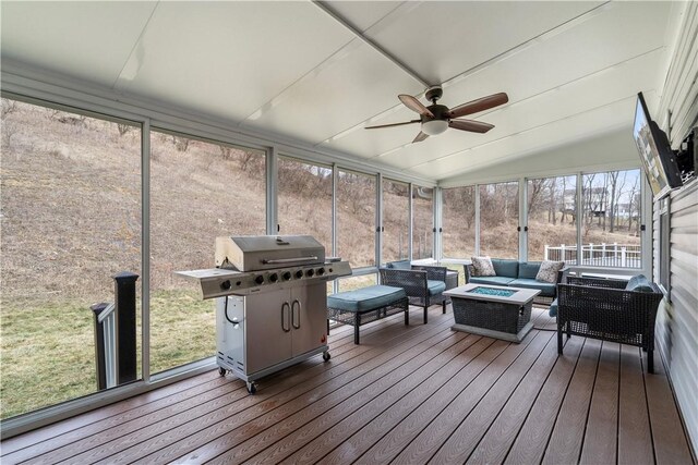 sunroom featuring vaulted ceiling and ceiling fan