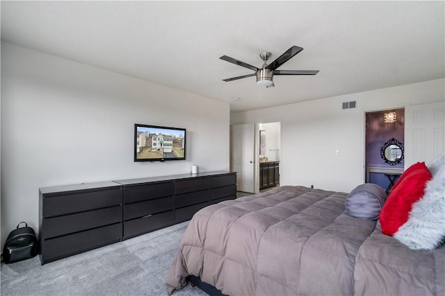 bedroom with ensuite bath, ceiling fan, visible vents, and light colored carpet