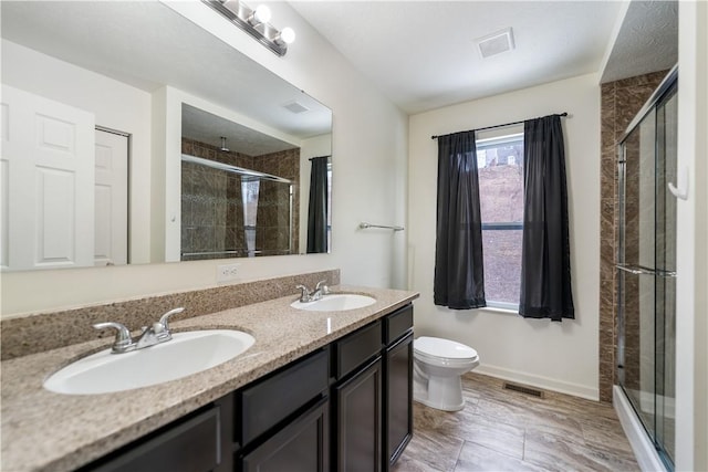 full bath with a stall shower, visible vents, and a sink