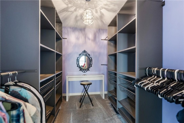 walk in closet featuring a chandelier