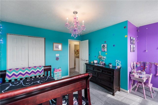 carpeted bedroom with baseboards, a closet, and an inviting chandelier