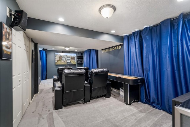 carpeted home theater with a textured ceiling and recessed lighting