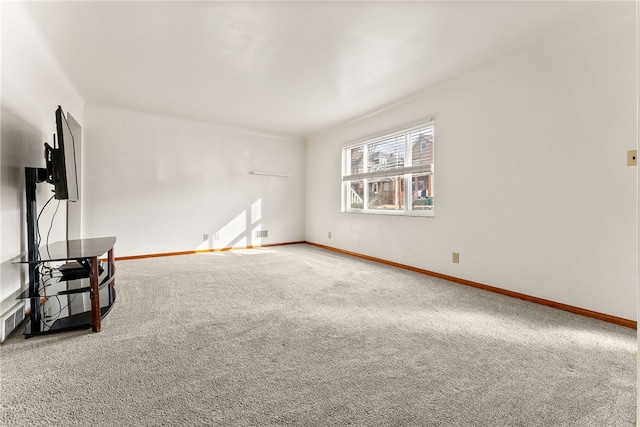 interior space featuring carpet and baseboards