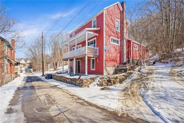 snow covered property featuring a balcony