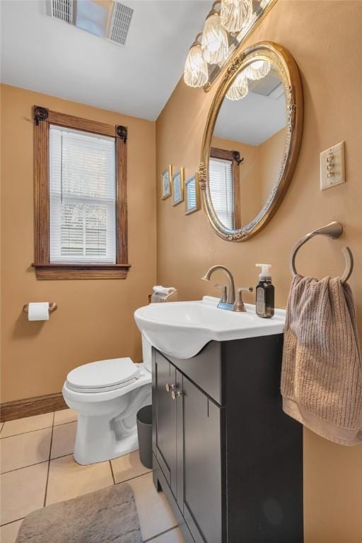 bathroom with tile patterned flooring, toilet, visible vents, vanity, and baseboards