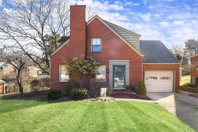 view of front of home featuring an attached garage, a chimney, and brick siding