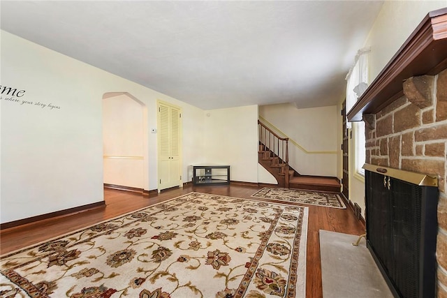 interior space with stairway, wood finished floors, and baseboards