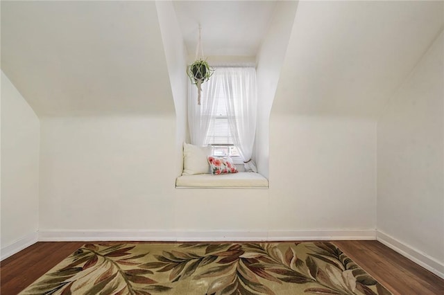 additional living space with wood finished floors and baseboards