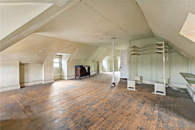 additional living space with vaulted ceiling and wood-type flooring