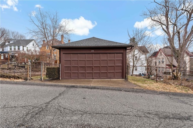 garage with a residential view and fence