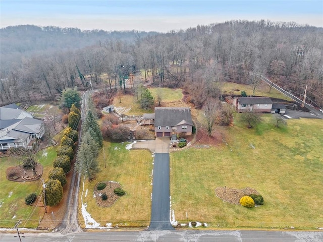 birds eye view of property featuring a view of trees