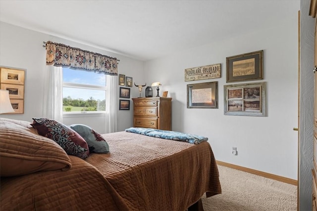 bedroom featuring carpet floors and baseboards