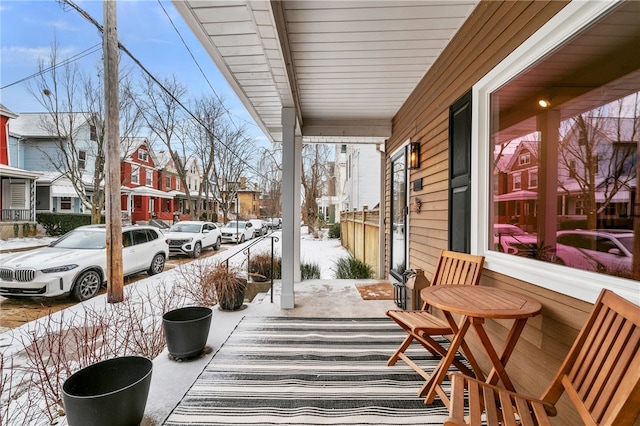 exterior space with a sunroom, a residential view, and a porch