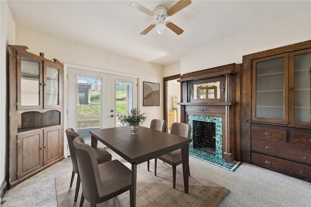 104 Georgetown Ave, West View, PA 15229 - dining room featuring light carpet, a tiled fireplace, french doors, and a ceiling fan