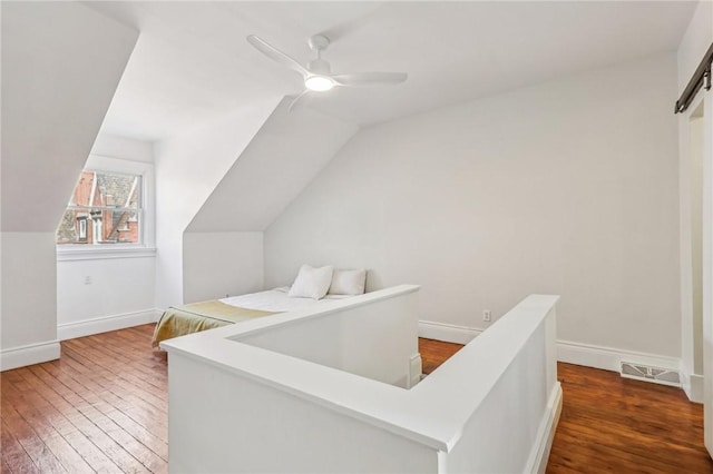 bonus room featuring visible vents, baseboards, a ceiling fan, lofted ceiling, and wood-type flooring