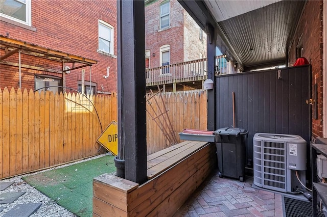 view of patio / terrace featuring fence and central AC