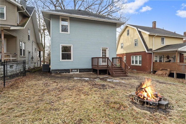 rear view of house featuring an outdoor fire pit, central AC, fence, and a wooden deck